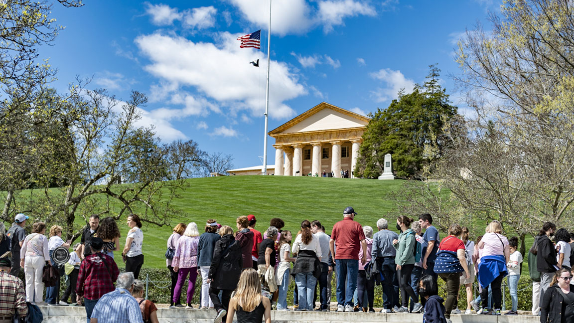 Photograph of Arlington House at Arlington National Cemetery, showing its historic mansion overlooking the grounds and tourists